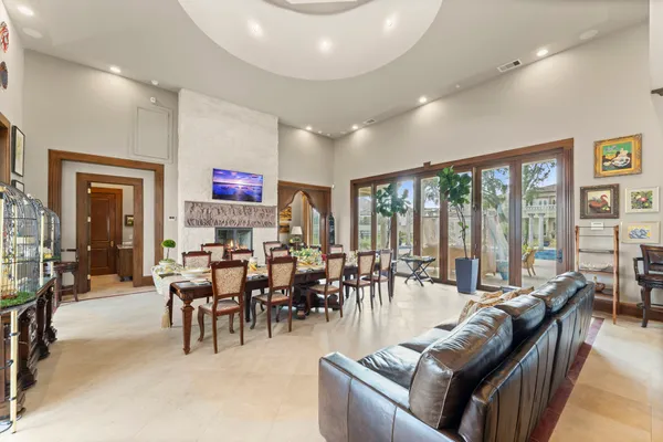 a backyard of a house with fountain table and chairs