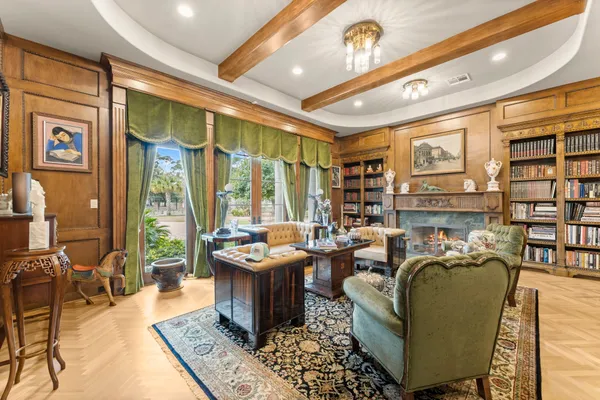 a living room with furniture a rug and a large window