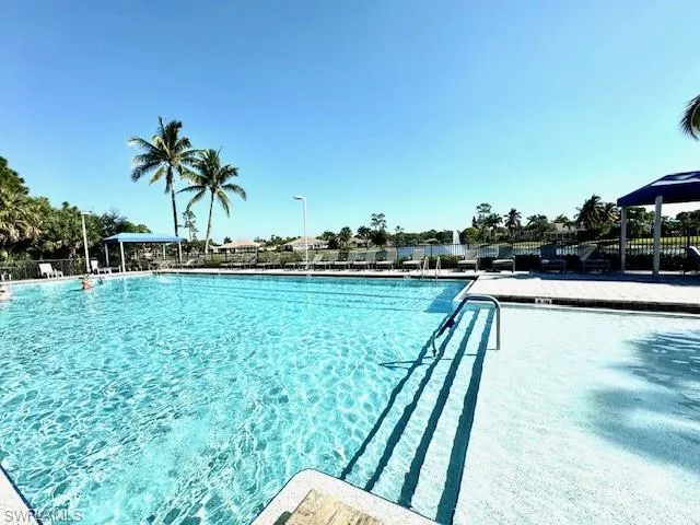 a view of a swimming pool with a garden and deck