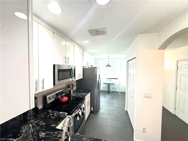 a kitchen with stainless steel appliances a refrigerator and a stove top oven
