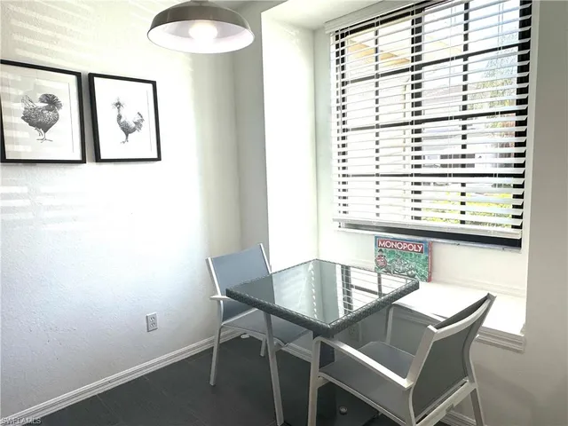 a view of a dining room with furniture and window