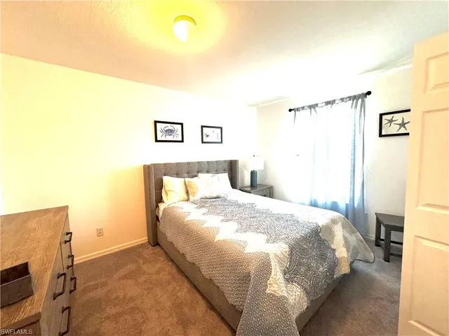 a bedroom with a bed and a tv
