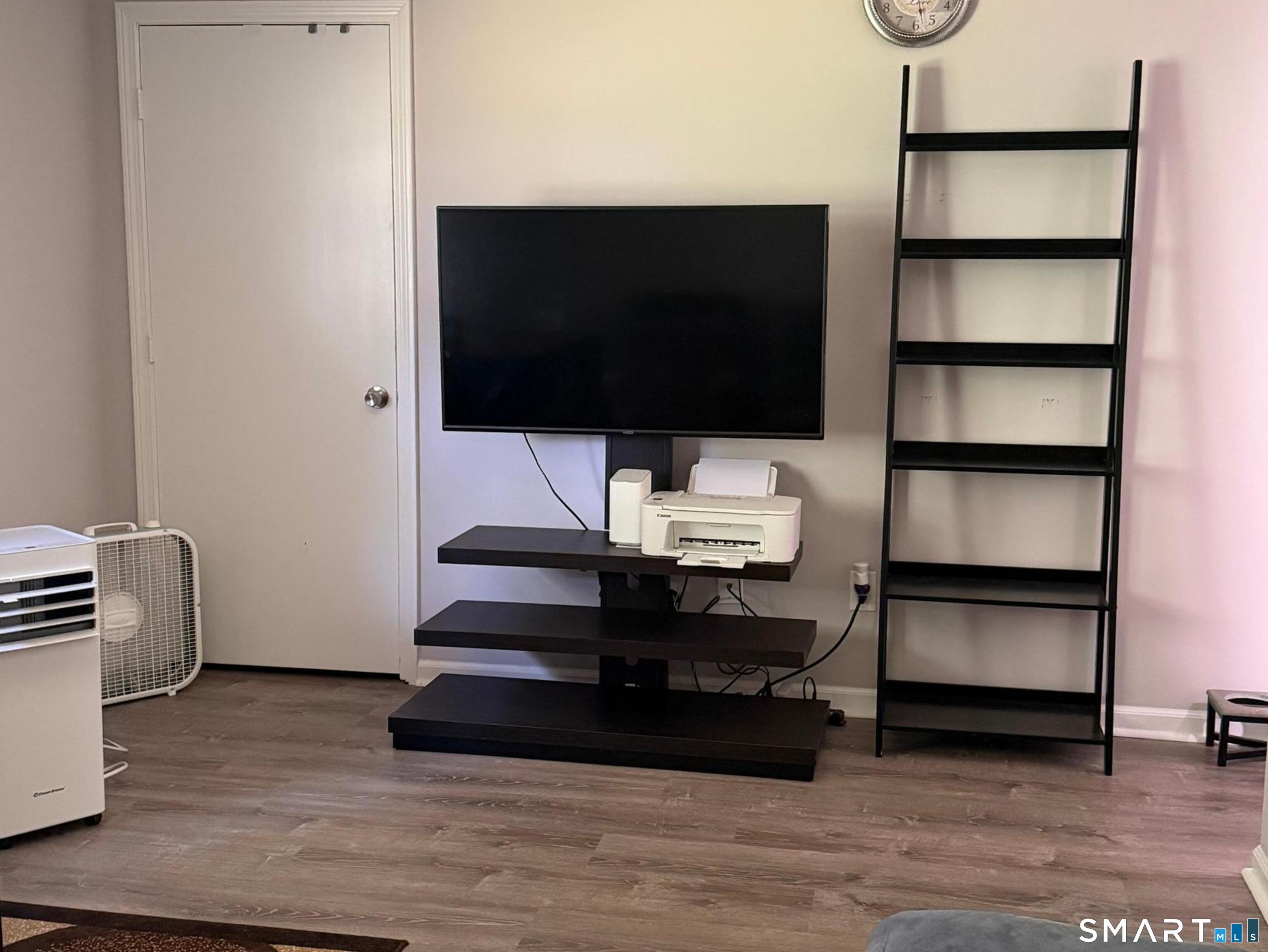 21 Lisa Court, Unit 10 Waterbury, CT 06704 - Photo 8 of 14 a living room with a flat screen tv and rug