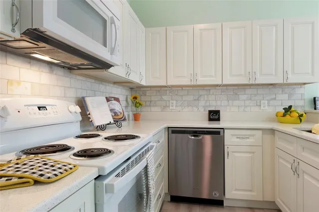 a kitchen with a sink a stove and cabinets