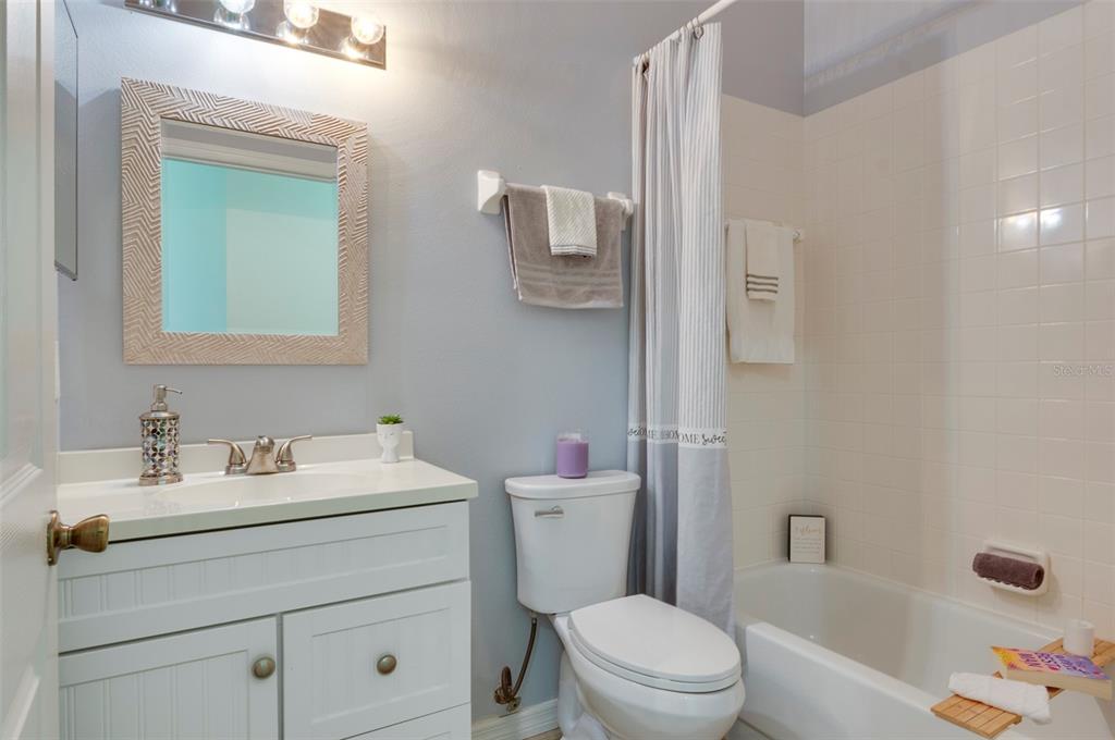 1050 Starkey Road, Unit 208 Largo, FL 33771 - Photo 22 of 30 a bathroom with a sink toilet vanity tub and shower