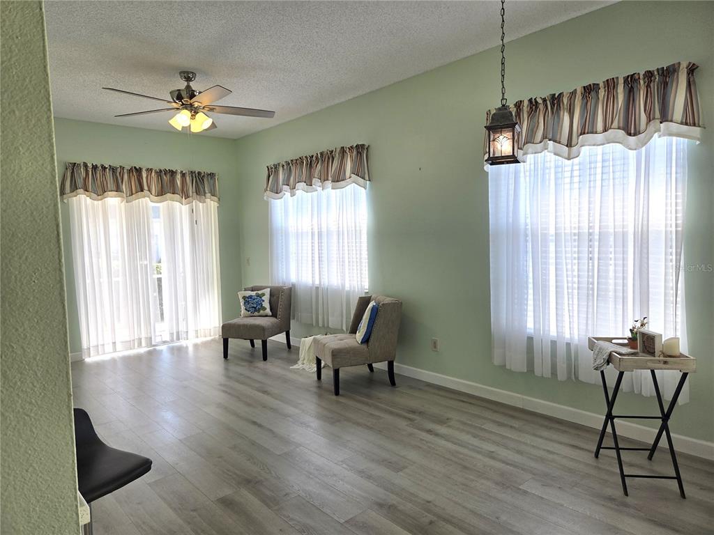 1050 Starkey Road, Unit 208 Largo, FL 33771 - Photo 7 of 30 a view of a livingroom with furniture window wooden floor and a chandelier