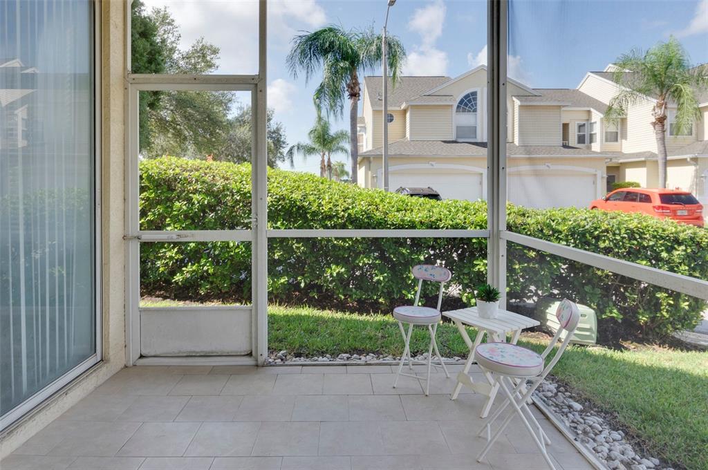 1050 Starkey Road, Unit 208 Largo, FL 33771 - Photo 9 of 30 a view of a chair and table in patio with wooden fence