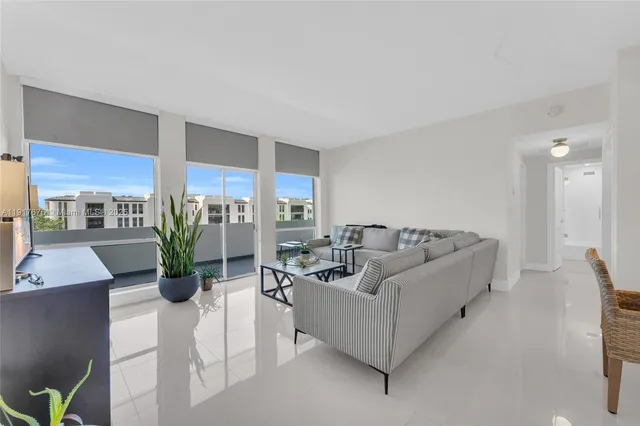 a living room with furniture windows and a table
