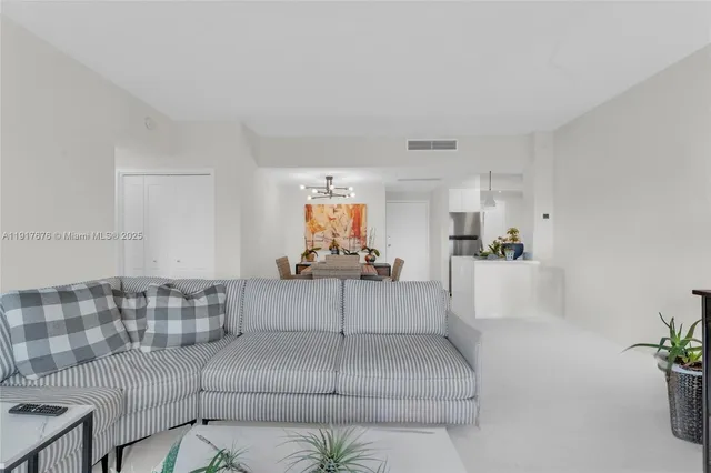 a living room with furniture and white walls