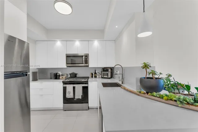 a kitchen with stainless steel appliances granite countertop a stove and a refrigerator