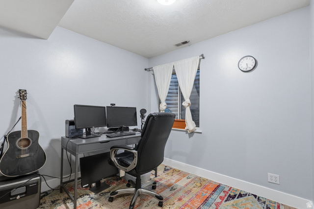 1099 South 950 East, Unit 17 Provo, UT 84606 - Photo 15 of 23 Office space featuring a window with white drapes, light blue walls, and white baseboards