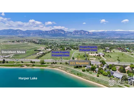 a open area with green field and trees in the background