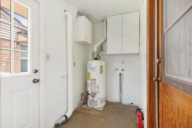 an empty room with a ceiling fan and a window