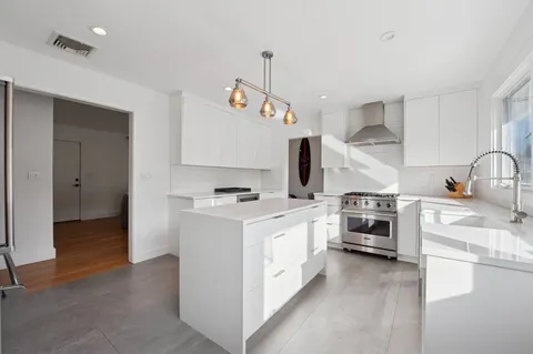 a kitchen with a stove a sink and a refrigerator
