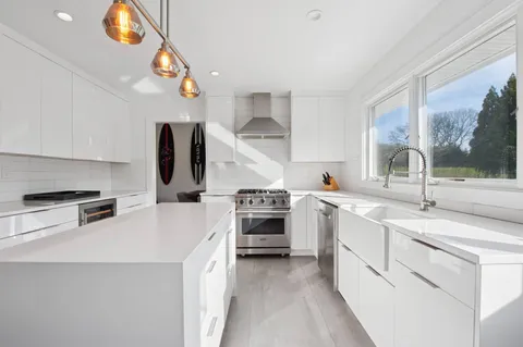 a kitchen with cabinets and stainless steel appliances