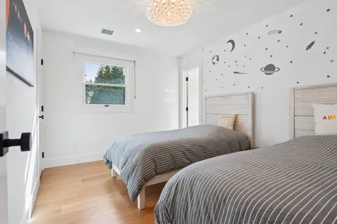 a bedroom with a bed and a painting on the wall