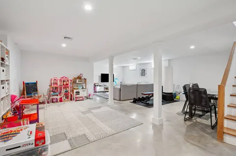 a bedroom with furniture and a gym equipment