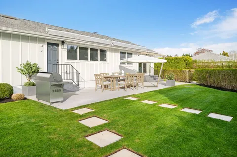 a front view of house with yard and outdoor seating