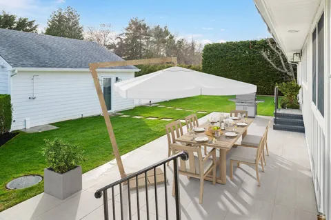 a view of an outdoor sitting area with furniture and backyard