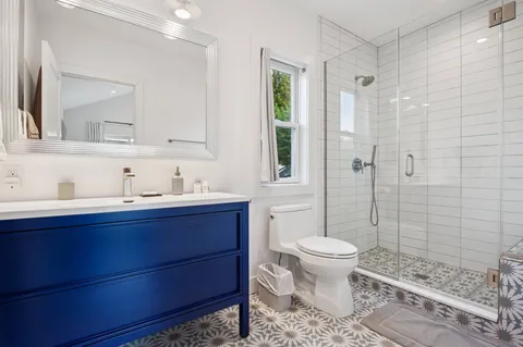 a bathroom with a sink toilet and shower