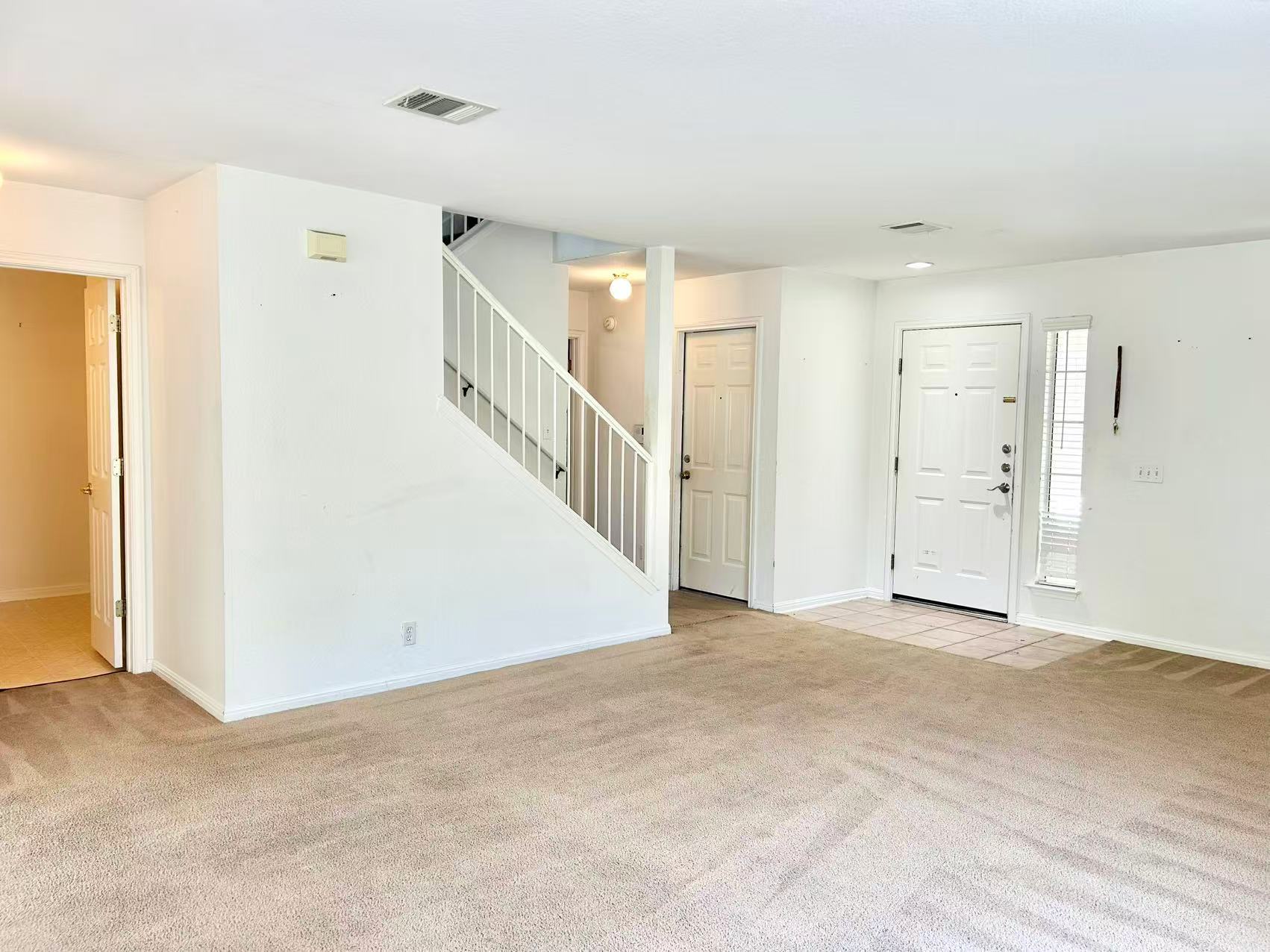 5608 Netleaf Road Austin, TX 78724 - Photo 4 of 26 A versatile living space with a classic staircase, ready for personal touches.