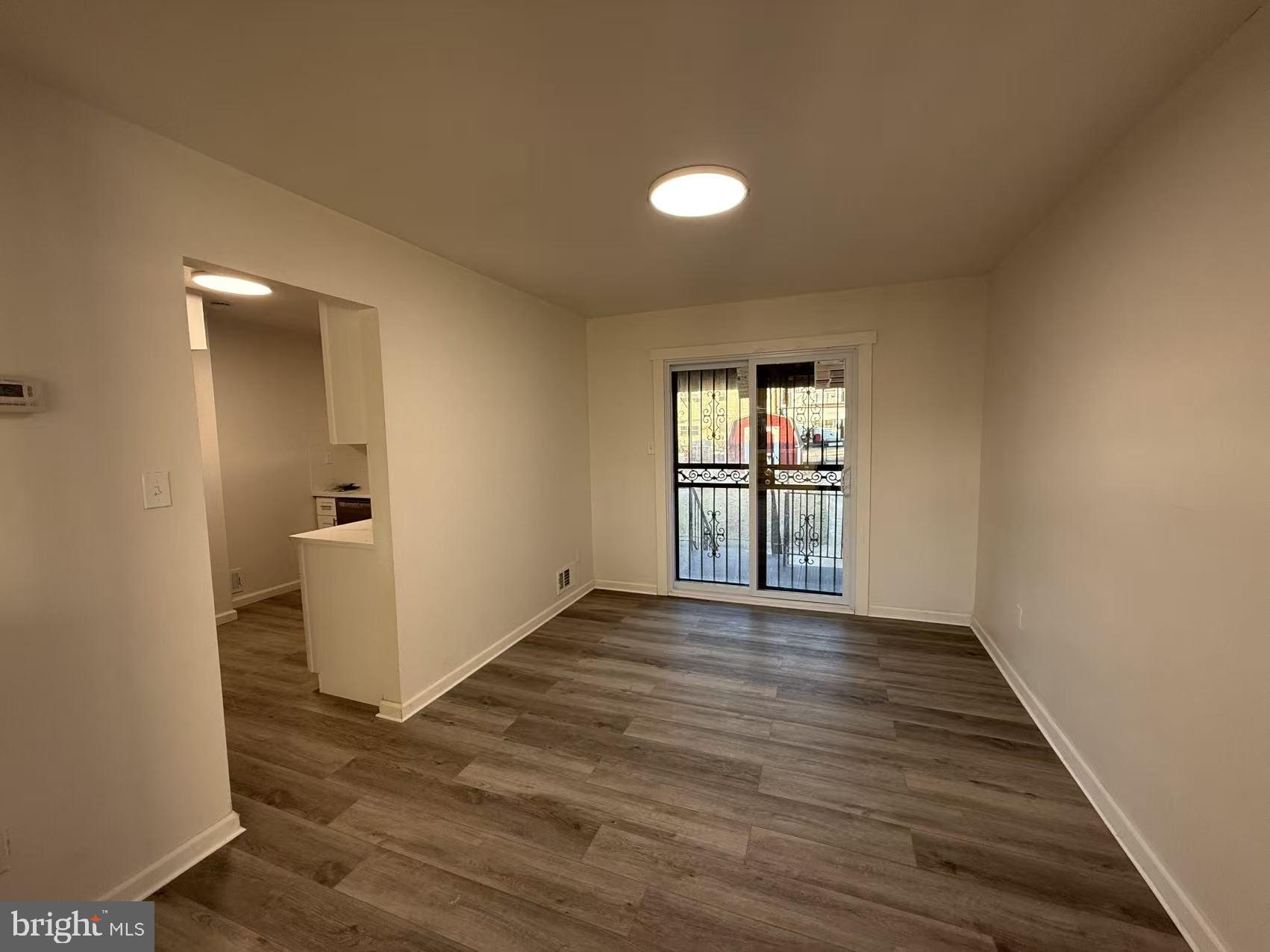 1328 W Street Northeast Washington, DC 20018 - Photo 5 of 25 wooden floor in an empty room with a window