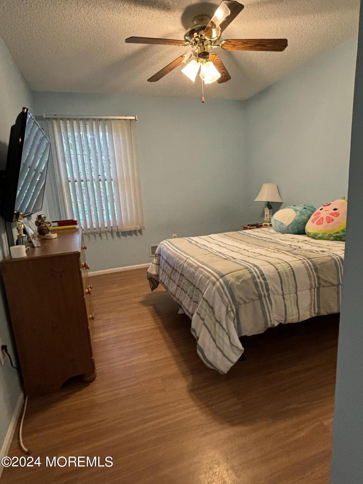 11 Springhill Drive Brick, NJ 08724 - Photo 11 of 15 a bedroom with a bed and a flat tv screen on dresser