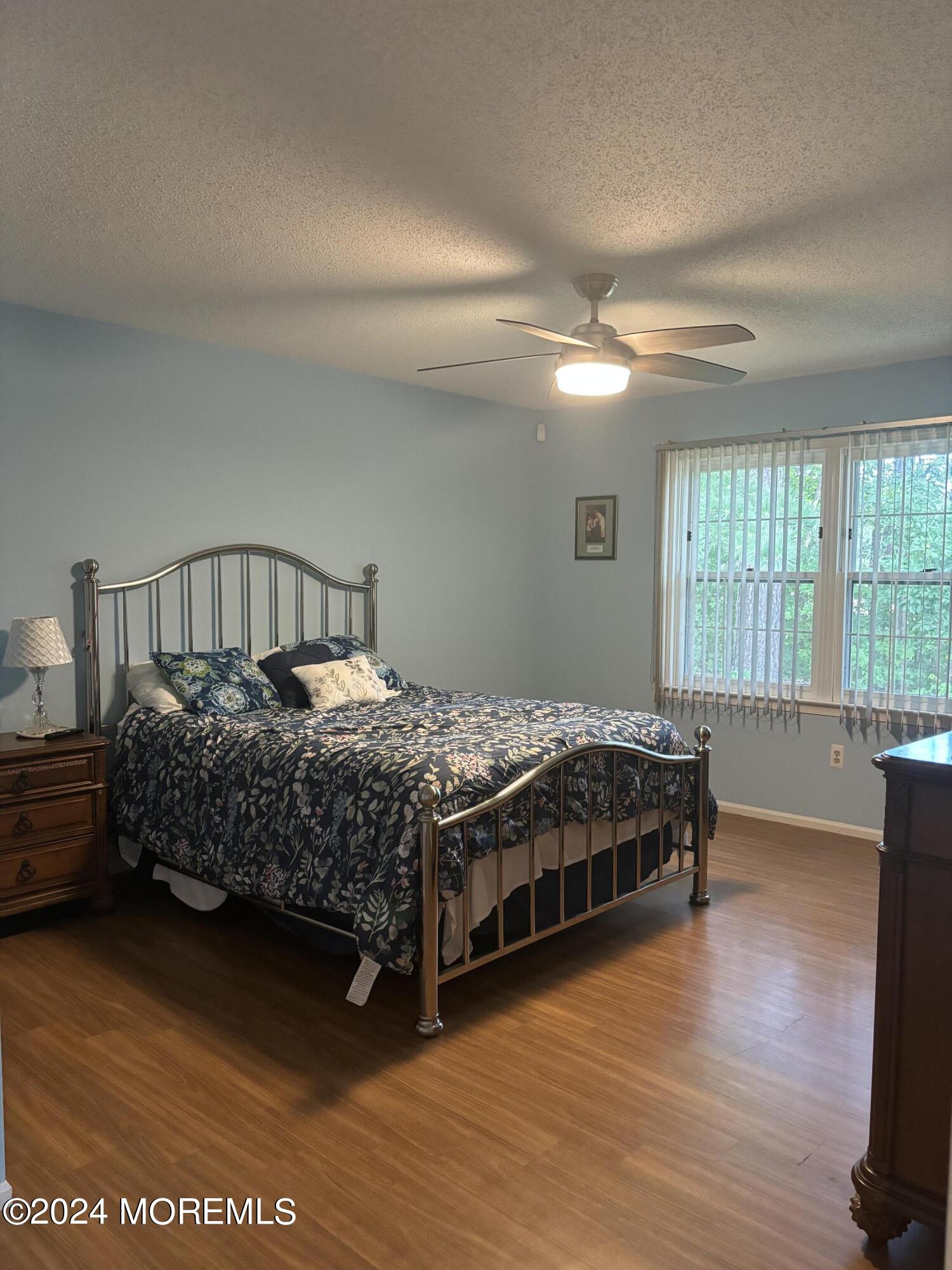 11 Springhill Drive Brick, NJ 08724 - Photo 7 of 15 a bedroom with a large bed and a chandelier