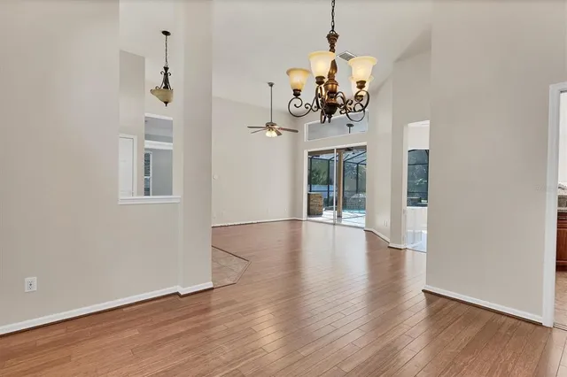 a kitchen with stainless steel appliances granite countertop a stove top oven a sink dishwasher a dining table and chairs