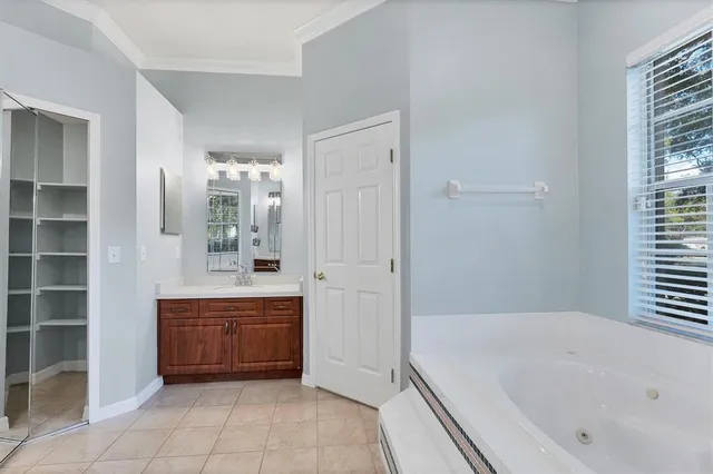 a bathroom with a granite countertop sink a mirror a vanity and shower