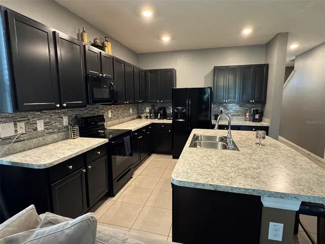 a kitchen with counter top space sink and stove