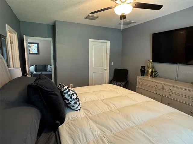 a bedroom with a bed and a flat screen tv