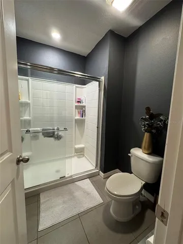 a bathroom with a toilet and a shower