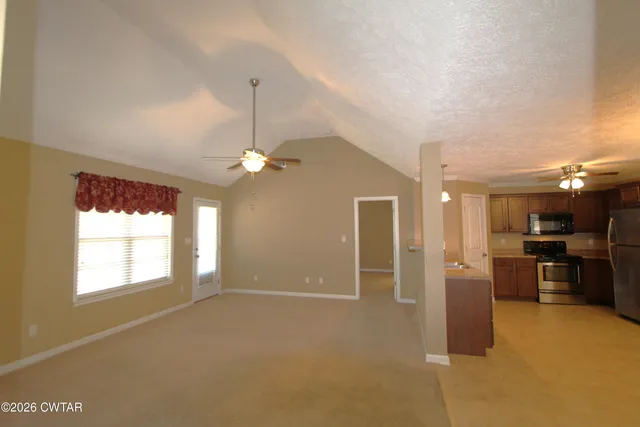 a view of a kitchen with a sink cabinets and stainless steel appliances
