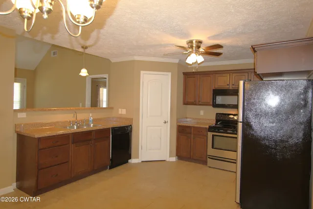 a kitchen with stainless steel appliances granite countertop a sink and refrigerator