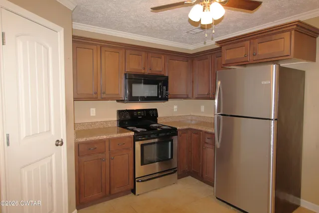 a kitchen with a refrigerator stove and microwave
