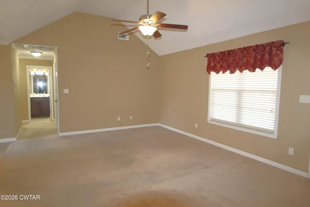 a view of an empty room with a window