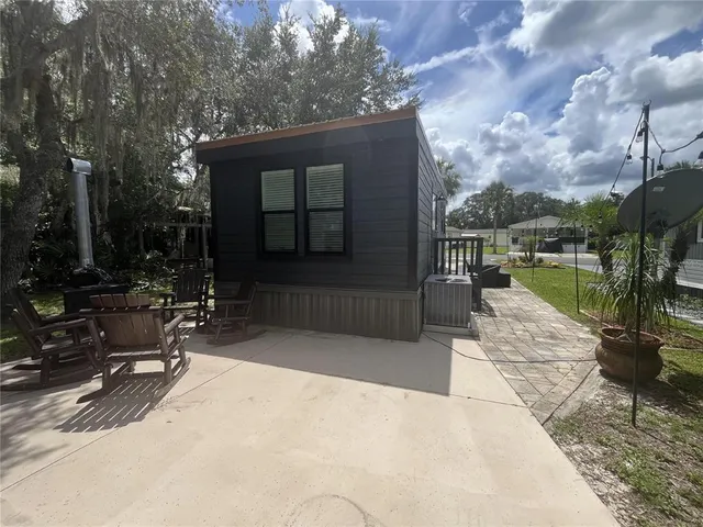 a view of swimming pool with outdoor seating and plants