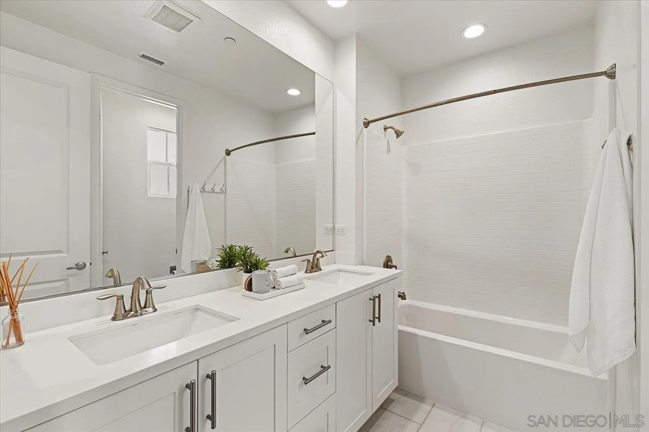 3008 Estero Road Carlsbad, CA 92010 - Photo 22 of 47 a bathroom with a double vanity sink mirror double and a bathtub