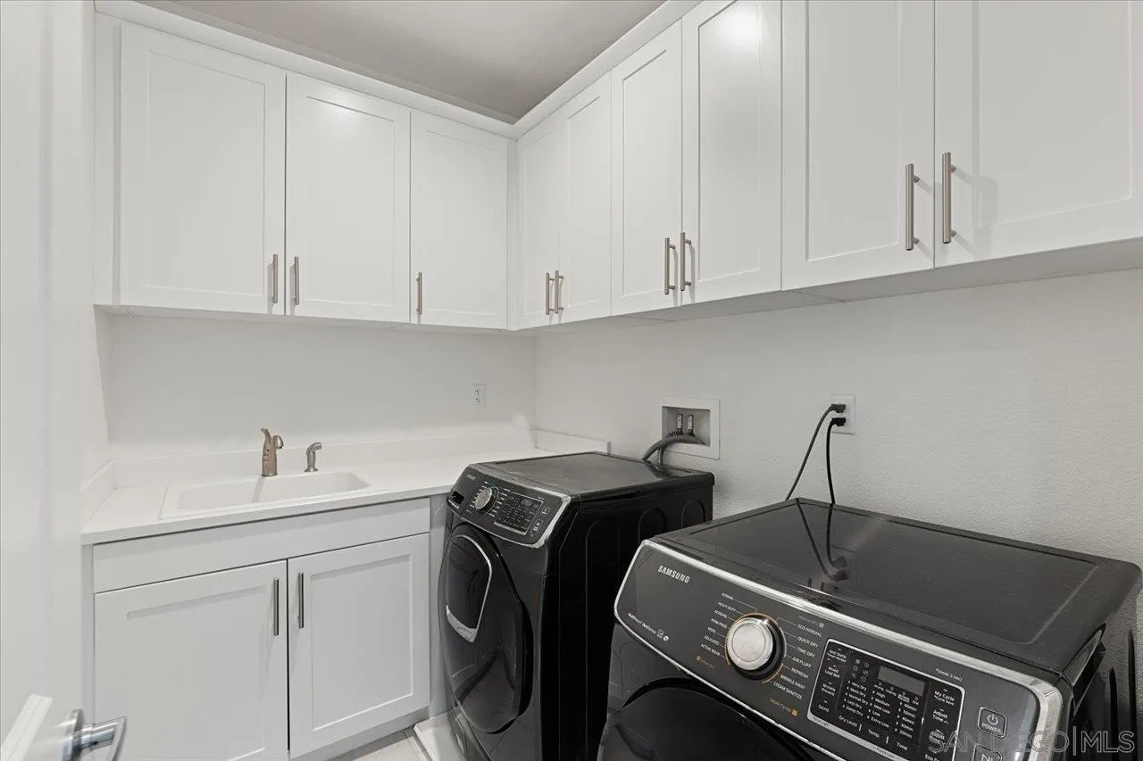 3008 Estero Road Carlsbad, CA 92010 - Photo 24 of 47 a kitchen with a sink and cabinets