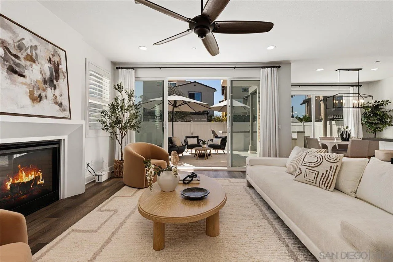 3008 Estero Road Carlsbad, CA 92010 - Photo 3 of 47 a living room with furniture a fireplace and a chandelier