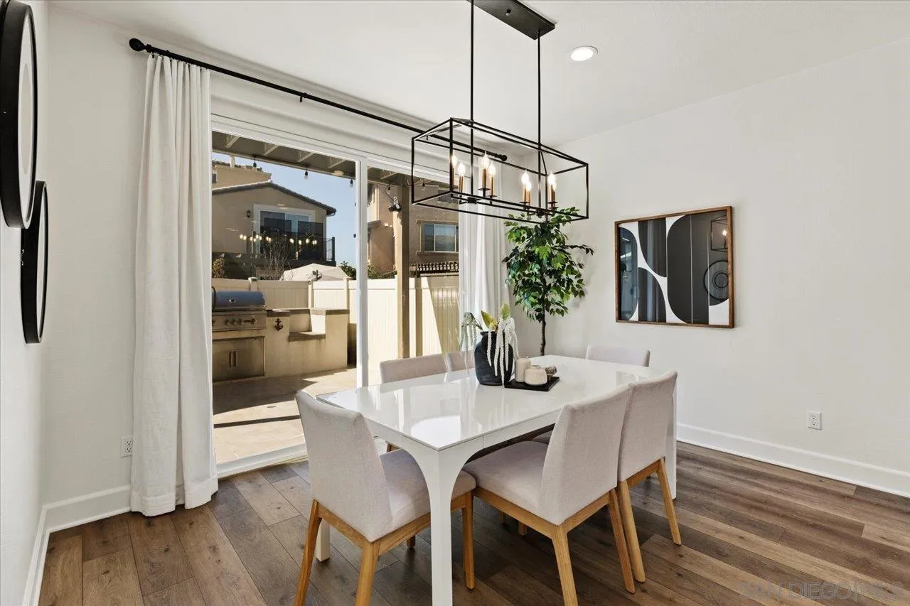 3008 Estero Road Carlsbad, CA 92010 - Photo 6 of 47 a view of a dining room with furniture and wooden floor