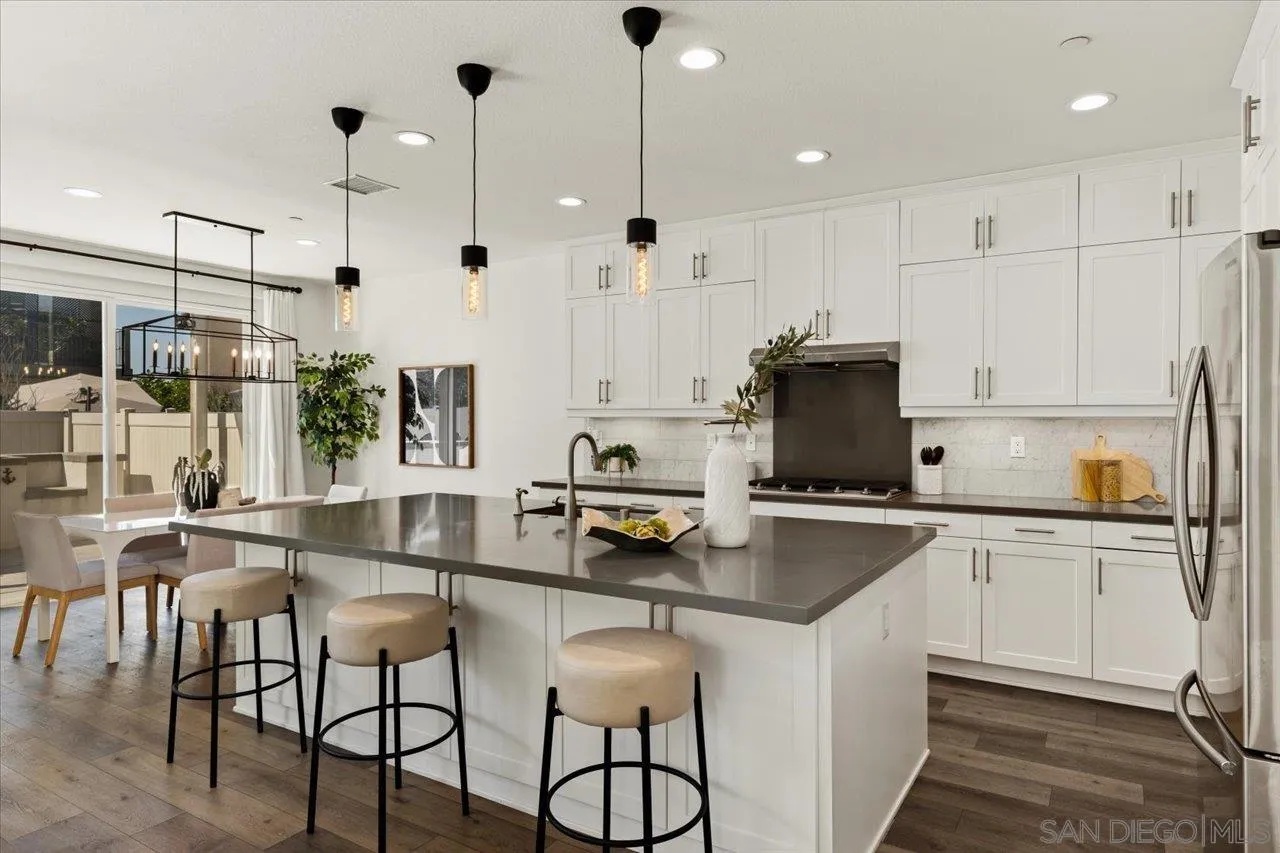 3008 Estero Road Carlsbad, CA 92010 - Photo 8 of 47 a kitchen with stainless steel appliances granite countertop a stove a sink and a refrigerator