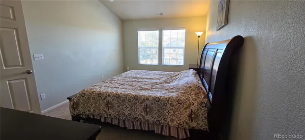 a bed sitting in a bedroom next to a window