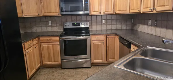 a kitchen with a sink and a stove top oven