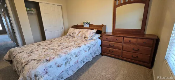 a bedroom with a bed and a mirror
