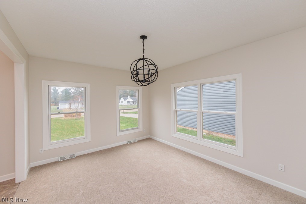 6947 Som Center Road Solon, OH 44139 - Photo 16 of 50 Spare room featuring a notable chandelier and light colored carpet