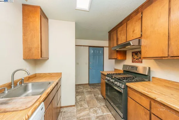 a kitchen that has a sink and a stove