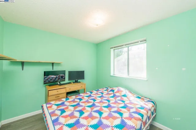 a bedroom with a bed and window