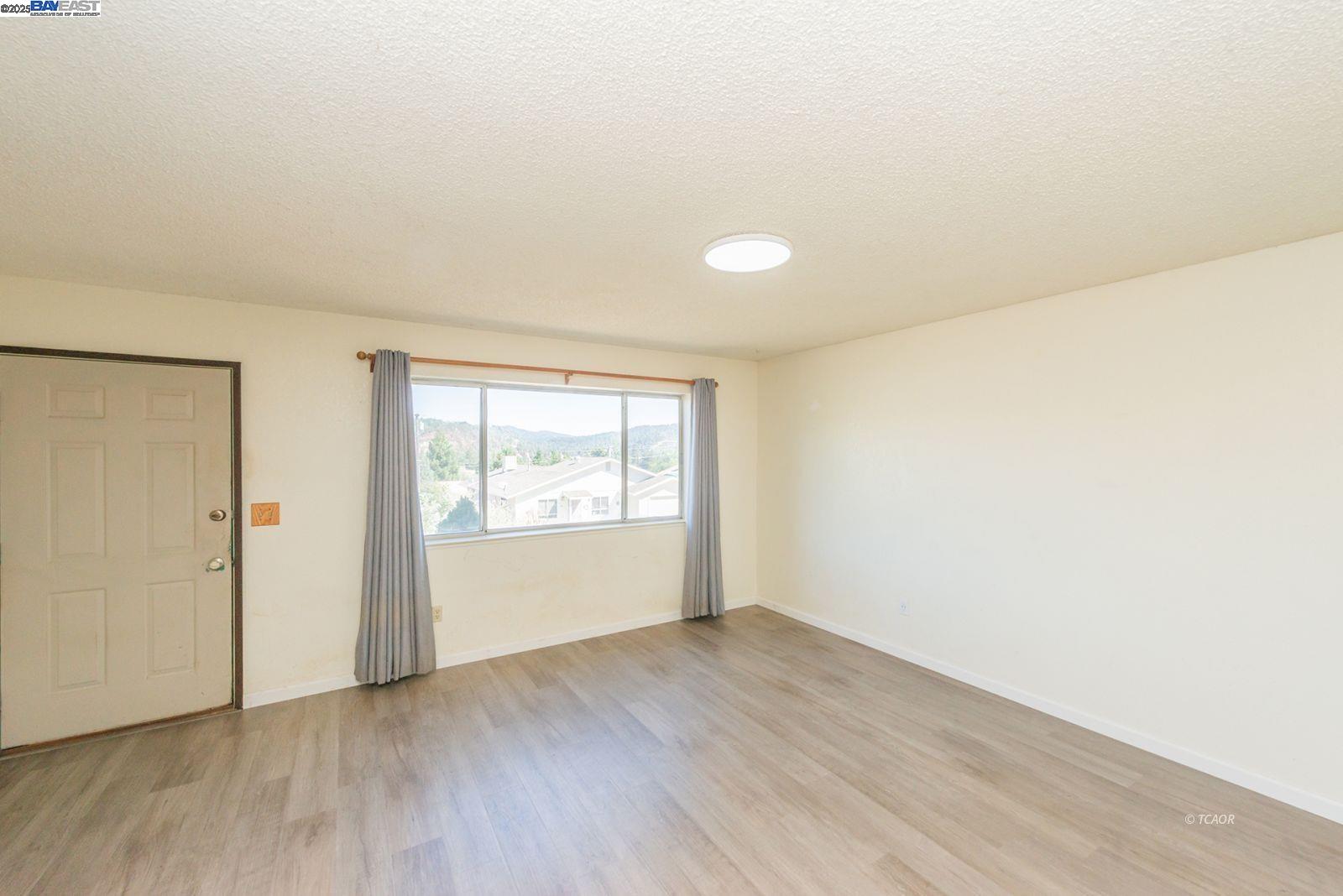 10 2nd Avenue Lewiston, CA 96052 - Photo 2 of 38 an empty room with wooden floor and window